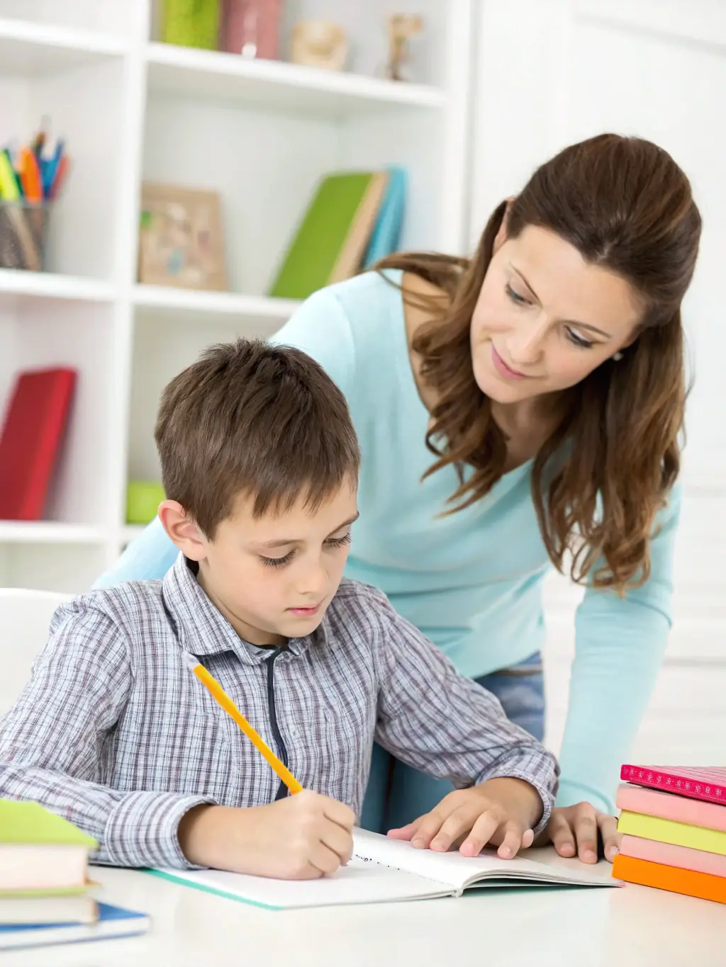 A child receiving tutoring and educational support from a dedicated SOS staff member, highlighting the organization's commitment to education.